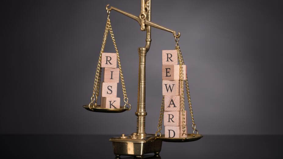 The words "risk" vs "reward" on different sides of a scale