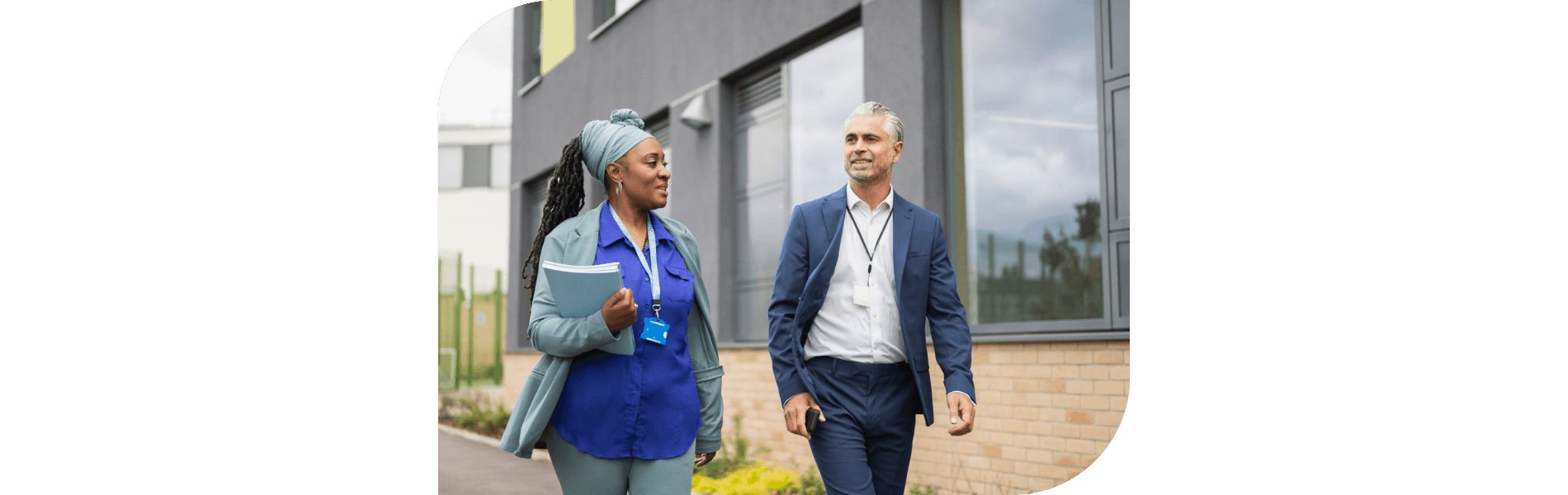 Male and female school administrators walking on campus